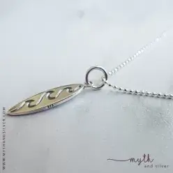 Sterling silver surfboard pendant shown on a ball chain