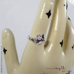 Claddagh ring shown on ceramic hand