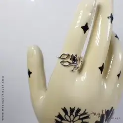 Silver openwork leaf ring shown on ceramic hand