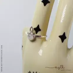 Silver moonstone ring on ceramic hand