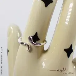 Sterling silver snake ring on ceramic hand